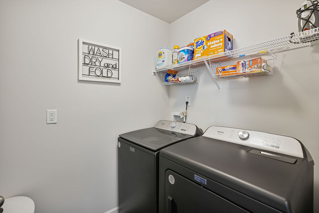 Main level laundry room with washer and dryer hookups and wire shelving in single-story home in Kirwin Village, Raeford NC near Fort Bragg