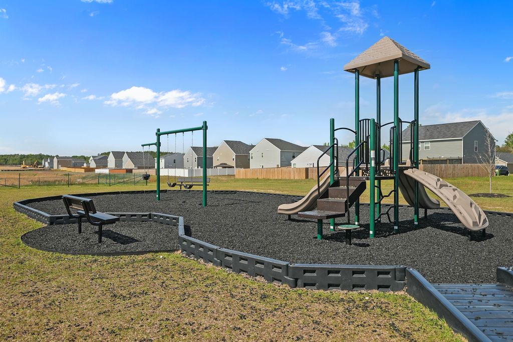 Kirwin Village community playground with swings, slide structure, and rubber mulch surface in Raeford NC near Fort Bragg