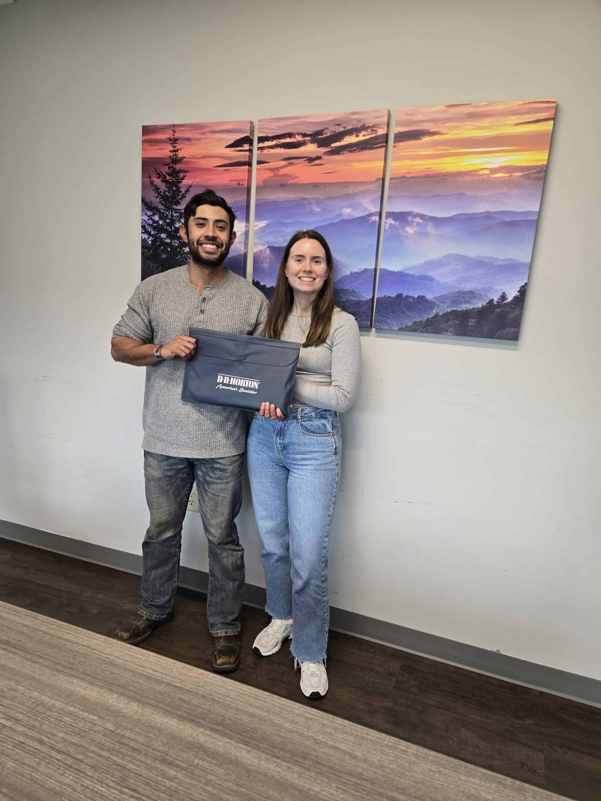 Military couple at new construction home closing with DR Horton