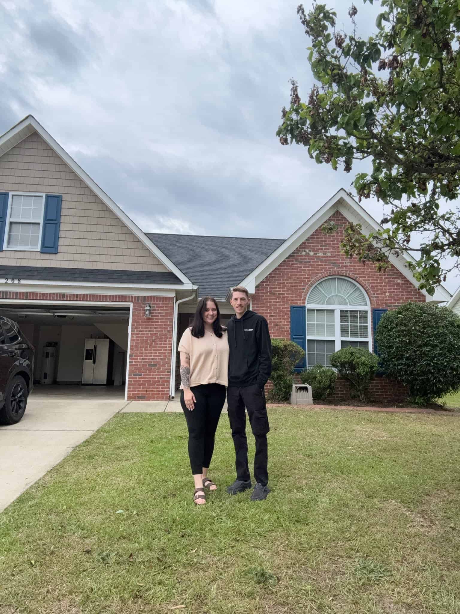 Military family couple standing in front of their new home near Fort Bragg NC